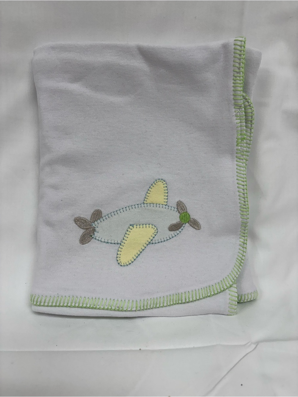 Soft White Baby Blanket with Green Trim and Airplane Applique